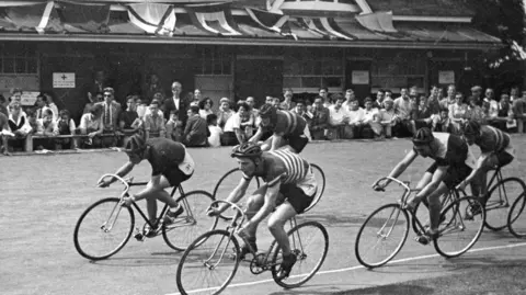 A black and white vintage image of cyclists on the velodrome at Preston Park  from 1950s