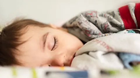 Getty Images Young child sleeping off illness