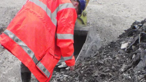 Environment Agency An Environment Agency officer inspecting illegal waste at Codicote Quarry, Hertfordshire