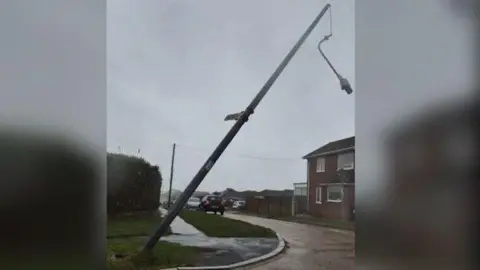 Sussex News a fallen lamp post in Peacehaven, East Sussex