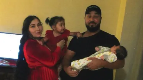 Peter Ivyani Photo of Florin Iordache, his wife Cristina and their two children