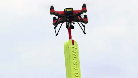 A drone carrying a tube buoy - a buoyancy aid