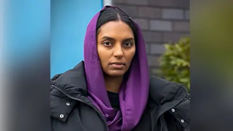 Coronation Street cast member wears a purple headscarf as part of the latest colour-themed episode.