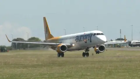 BBC An Aurigny-branded jet landing at Guernsey airport 