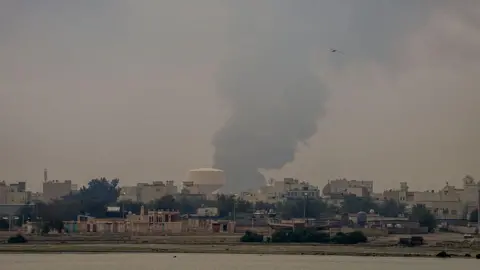 Plumes of smoke rise over fuel tanks in Muharraq, Bahrain on 12 March. 