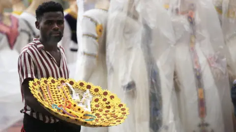 Getty Images Ethiopian man sells Biden's flower motif ornaments known as "Adey Abeba" ahead of the new year in Addis Ababa, Ethiopia on September 06, 2022.