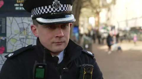 Supt Luke Dillon stands in the high street in Croydon