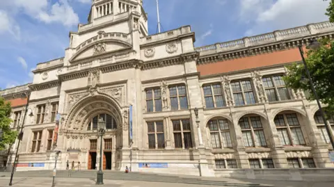 Google image of the outside of the V&A museum on a blue sky day. 