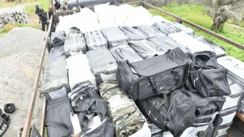 Liberia National Police/Facebook A police lorry is loaded with dozens of black bags and sealed packages in Monrovia