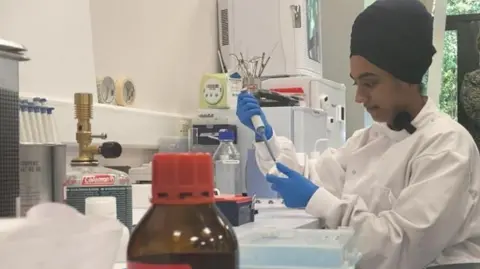 A view of a researcher preparing samples to be analysed in a machine.