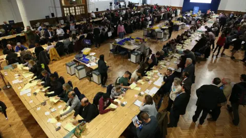 Jonathan Brady Count volunteers sort ballot papers at Lindley Hall, Westminster