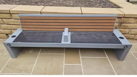 Wrexham Council Grey metallic bench with USB ports at either end