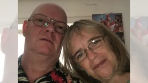 Richard Munson Richard Munson - a bald man with glasses - next to his wife Wendy - a woman with mid-length blonde hair and glasses