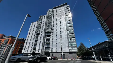 A general view picture of the high-rise Lexington Apartments building, which is clad in silver-coloured cladding.