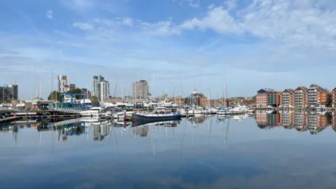Jon Wright A view of Ipswich waterfront on a sunny day. Boats and buildings are reflected in the water. 