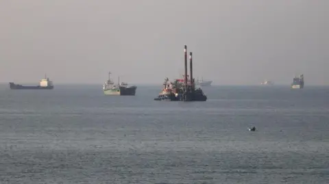 Reuters Six shipping vessels successful  the Strait of Hormuz adjacent   Bandar Abbas, Iran connected  Monday.