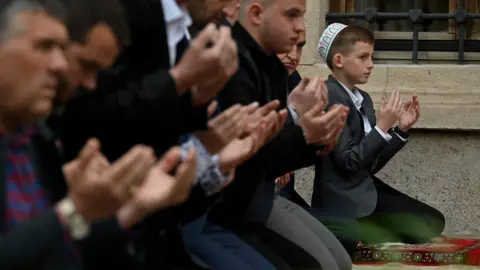 Getty Images Albanian Muslims praying