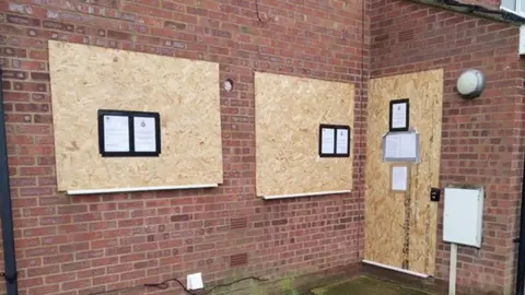 Northamptonshire Police Brick-built house with boards over windows and doors