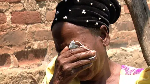 Woman covering her face with a handkerchief