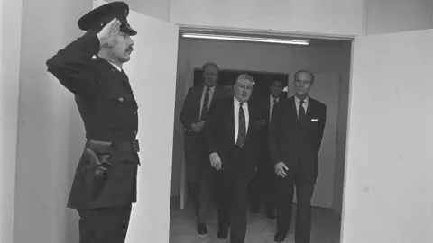 Pacemaker An RUC officer salutes Prince Phillip as he enters the King's Hall to officially open the 1991 Ulster Motor Show During a one-day visit. 11-02-1991