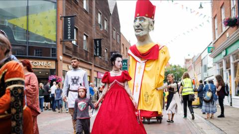 An effigy of St Thomas Becket being paraded through the streets of Canterbury