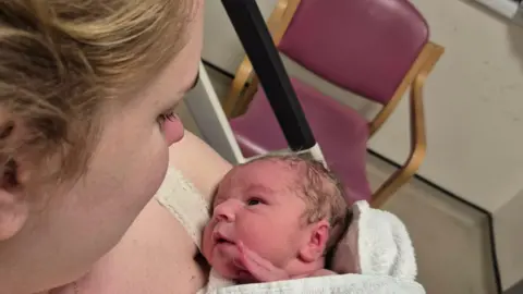 Abbie Foord holding her new-born baby