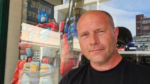 Paul Moseley/BBC Joe Sutton, with a cardboard cut-out of Optimus Prime