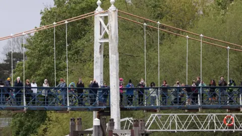 Reuters Onlookers crowded onto a bridge and the towpath at Teddington to look for the whale