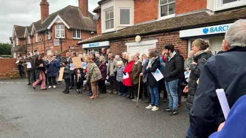 Emma Baugh/BBC Dozens of protesters outside Barclays in Leiston