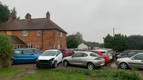 Carmelo Garcia A car park of Ford Fiestas on Mr Smith's land, next to his house.