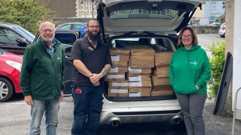 Two workers from Weston Foodbank receive food boxes from The Grand Pier