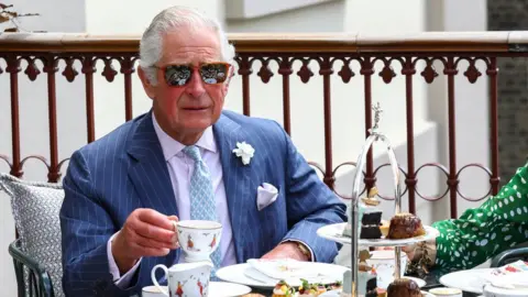 Reuters Britain"s Prince Charles drinks tea on the terrace during a visit to Theatre Royal in London,