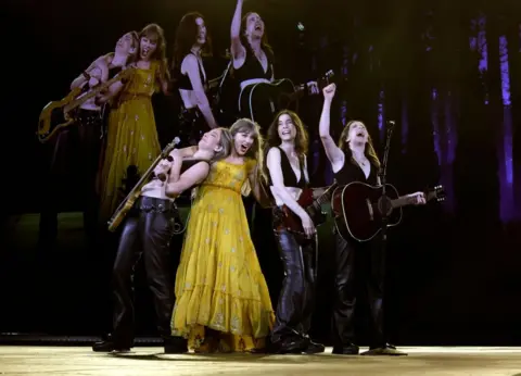 Getty Images Haim on stage with Taylor Swift