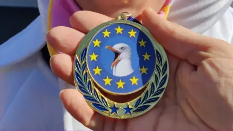 Family photo Cooper's medal