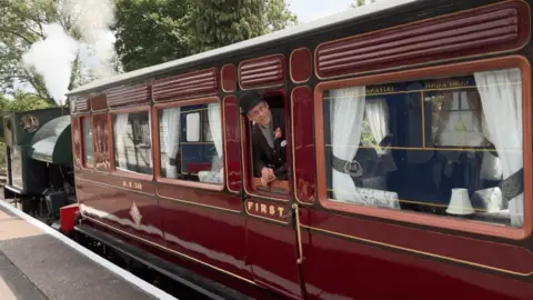 Midland Railway company coach at the platform ready to depart