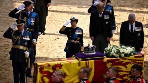 PA Media Royal family salute the coffin of Queen Elizabeth II