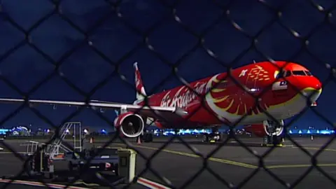 ABC The AirAsia X plane on the tarmac at Brisbane Airport