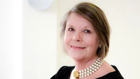 PORTSMOUTH NHS TRUST Melloney Poole wearing a pearl necklace