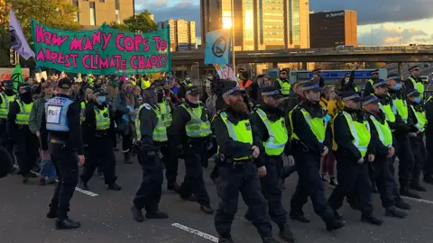 BBC Police march at the front of a protest in Glasgow
