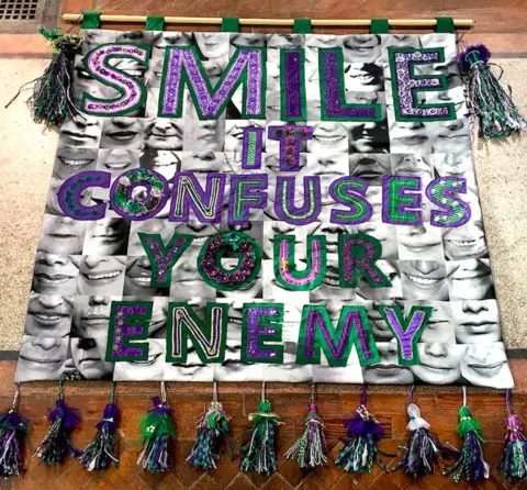 Artichoke "Smile it confuses your enemy" banner by Junction Arts in Bolsover, Derbyshire, with textile artist Karina Thompson
