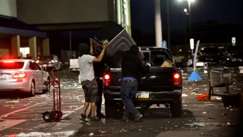 Getty Images People place merchandise from a hardware store into a truck during widespread in Philadelphia, Pennsylvania, 31 May 2020