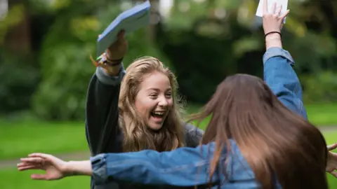 Matthew Horwood Imogen Lloyd (L) celebrates with Hollie Jones after receiving her GCSE results at Ffynone House School, Swansea