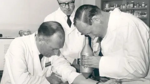 Boots Dr Stewart Adams, Dr John Nicholson and Mr R Cobb studying degrees of inflammation using a colour intensity measuring device