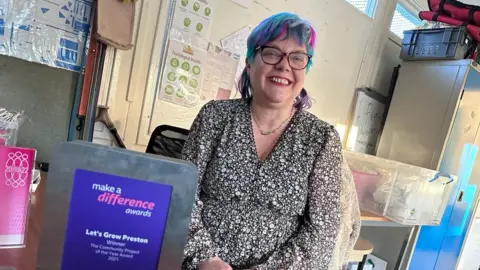 BBC Annie Wynn from Let's Grow Preston with her award from the BBC