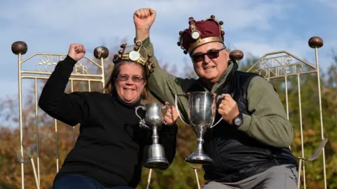 PA Media Women's champion Fee Aylmore and Mens champion Randy Topolnitsky from Calgary in Canada, winners at the annual World Conker Championships at the Shuckburgh Arms in Southwick