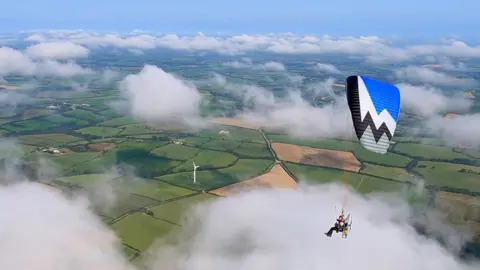 John Pavitt Daniel Jones in a paramotor near Torrington in Devon