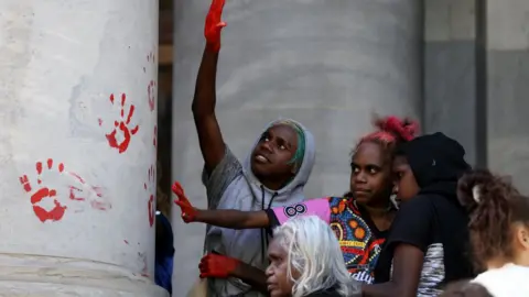 EPA Protesters leave red handprints on the columns outside the South Australia Parliament on 13 November