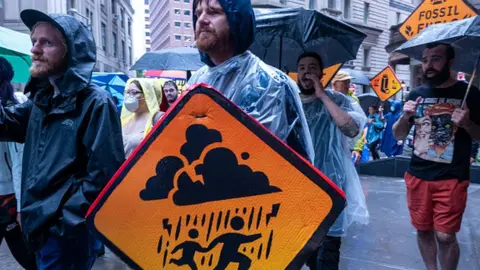 Getty Images Protesters hold a climate protest in New York ahead of the summit