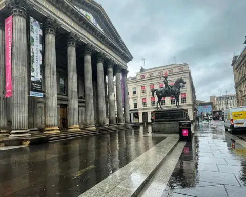 BBC Weather Watcher Tartan Trunks Very wet streets in Glasgow with the Wellington Statue in the background.