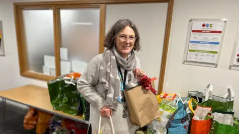 BBC Ben Moore Emma Lander from the Sustain Foodbank in Tonbridge packing up bags of food 